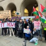 Manchester's Green councillors with supporters holding banners outside Manchester Town Hall