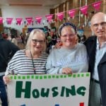 Cllrs Astrid Johnson and Rob Nunney with Green candidate Zoe Marlow. They are smiling at the camera and holding a banner which reads 'Housing for all!'